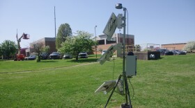 An air quality sensor with solar energy panels in front of Kalamazoo's wastewater treatment plant.