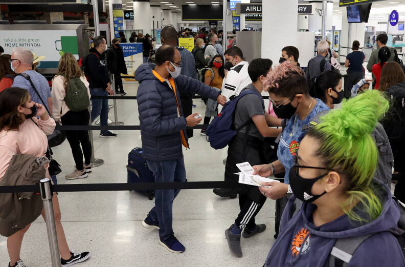 Travelers make their way through Miami International Airport on Tuesday.