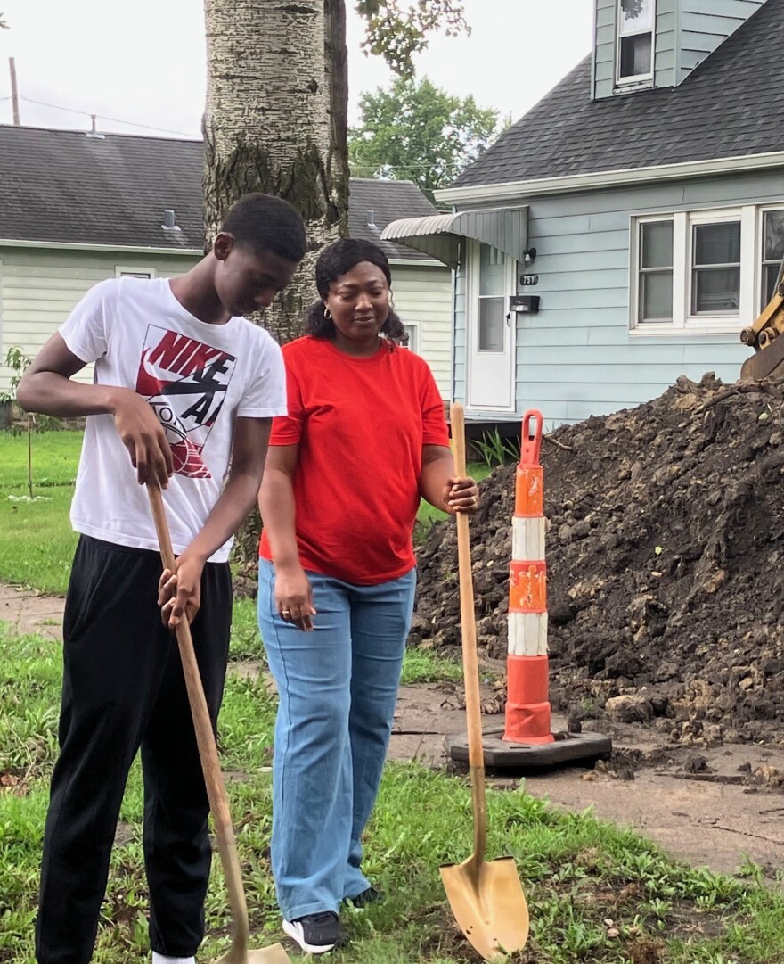 Habitat homeowner Hugette (right) looks on as her son Lionel takes part in the groundbreaking at their future East Moline home, Saturday, Aug. 15, 2026.