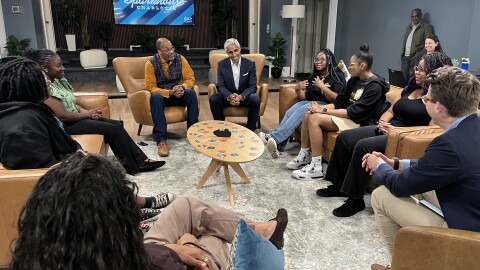 Former U.S Surgeon General Dr. Vivek Murthy sits with a group of high school students in west Charlotte, talking about address lonelines and isolation.