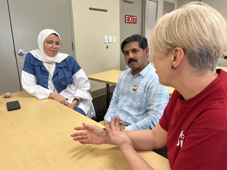 Fulbright Scholars Abir Ghenaiet, Vijay Kumar and Inna Korytova chat in a Florida Gulf Coast University classroom. They are part of a class of international students studying teaching techniques in the United States.