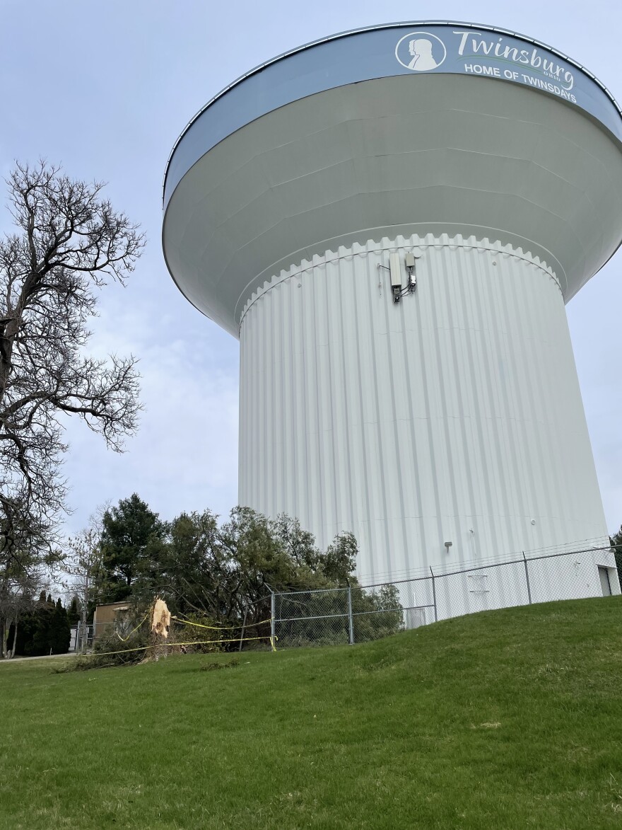 A tree lies across the security fence surrounding a water tower in Twinsburg, March 14, 2026.