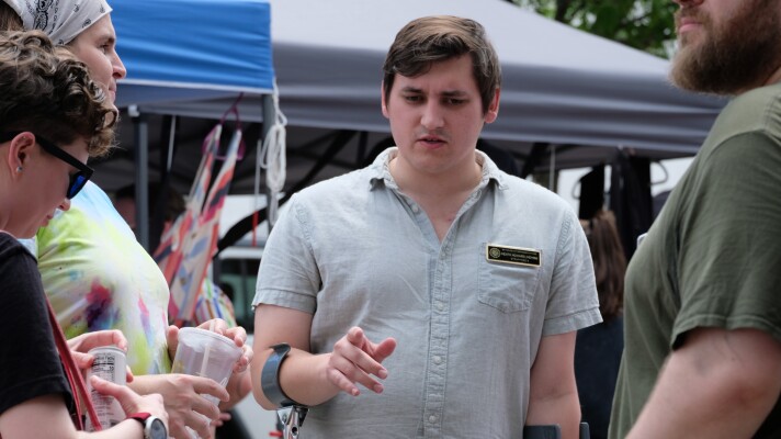 New Hampshire State Rep. Heath Howard, who is running for Congress, speaks with voters during Rochester Pride on Aug. 1, 2026.
