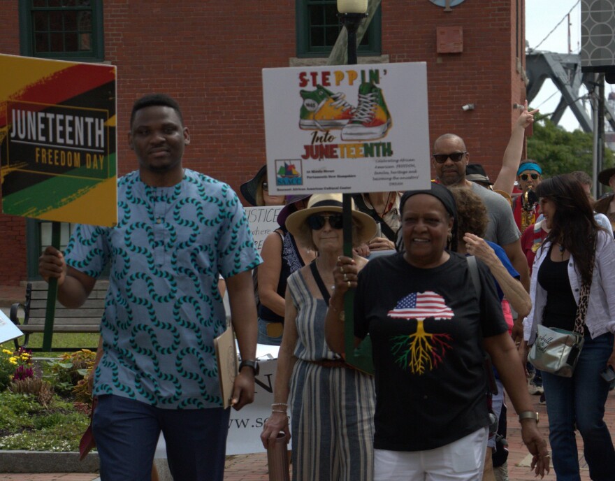 Sandi Clark Kaddy, President of the Seacoast African American Cultural Center (right), leads the Freedom Walk from Kittery into Portsmouth on Thursday morning.