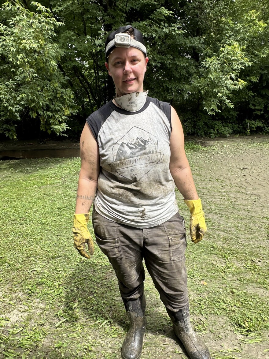 Woman standing with face mask and dirt all over and rubber gloves