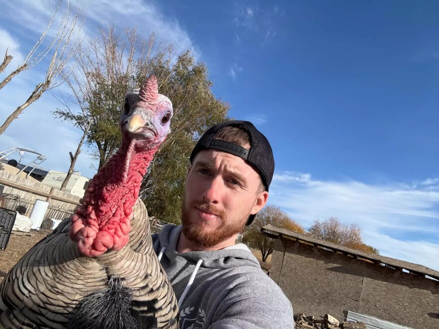 Nathan Cottrell holds his tom turkey, Nag. This bird will be spared this year because it’s part of Cottrell’s breeding program.