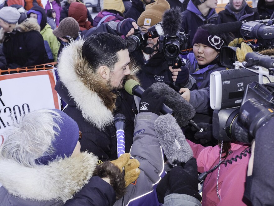 The hometown here, Pete Kaiser of Bethel, is swarmed by media as he claimed his second consecutive K300 title. (Photo by Chris Pike/KYUK)