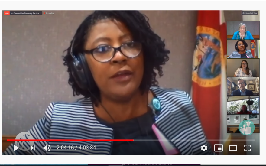 African-American woman speaks on a Zoom call with other school board members