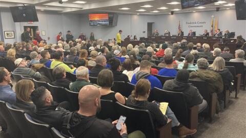 Frederick County residents wait their turn to speak out on data centers at a public meeting the week before the vote