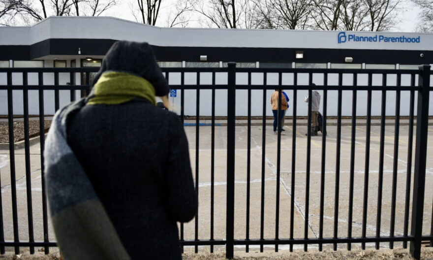 An activist with 40 Days for Life prays as she stands outside the Columbia Planned Parenthood clinic on Monday, March 3, 2025 shortly after the clinics restarted procedural abortions under the state's reproductive rights amendment.