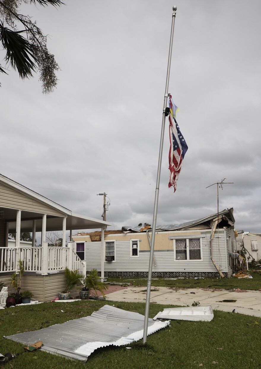 An American flag flies at half-mast on Thursday (9/29/22) afterr Hurricane Ian damaged hundreds of mobile homes in Suncoast Estates in North Fort Myers.