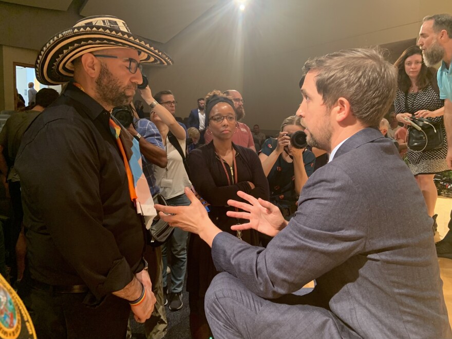 Diego Villada, left, New College of Florida assistant professor of theater and performing studies, speaks with new board of trustee member Christopher Rufo after the first of two public town halls in Sarasota on Jan. 25, 2023.