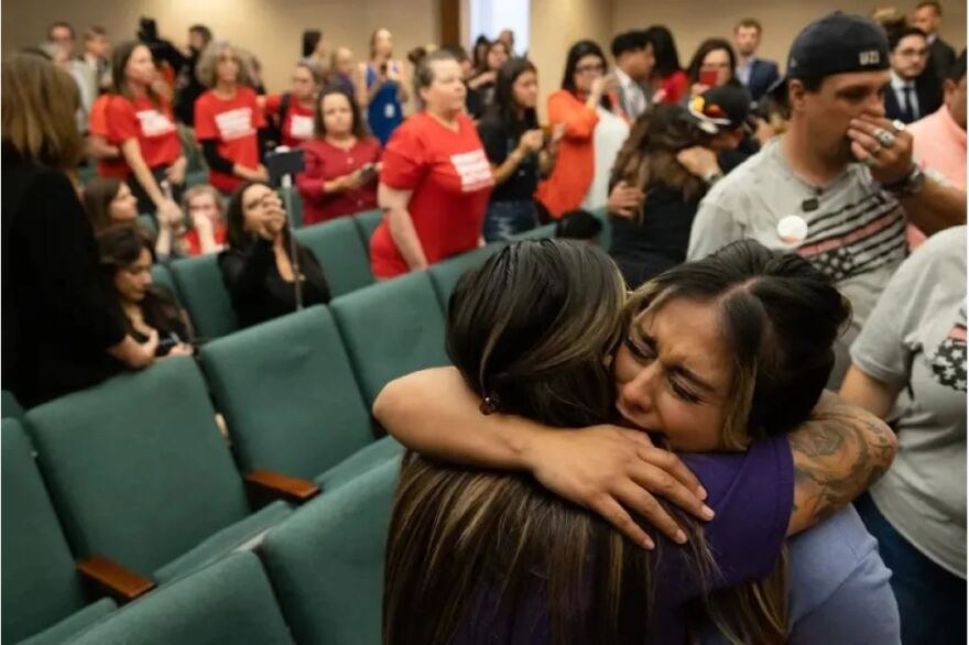 Family members of victims of the Uvalde shooting cry and hug one another at the Capitol on Monday after a Texas House committee voted in favor of House Bill 2744, which would raise the minimum age to purchase semi-automatic rifles from 18 to 21.