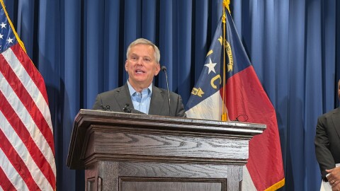 Gov. Josh Stein is calling for the U.S. Congress to appropriate billions more dollars to North Carolina's recovery from last year's Helene. The storm drenched western North Carolina, causing widespread flooding and at least 107 deaths. Here, Stein is shown speaking at a September 2 press conference.