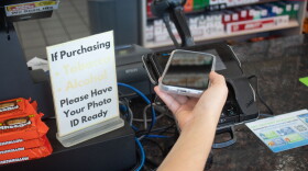 A person uses an iPhone to digitally complete a transaction at a gas station in Oklahoma City. 