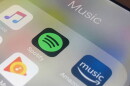 Icons of music streaming platforms on a phone screen.