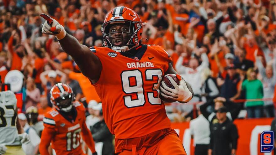 Syracuse defensive lineman Caleb Okechukwu celebrates after returning an interception for a touchdown in the fourth quarter of Saturday’s game against Purdue. This play and the ensuing PAT would give the Orange a 25-15 lead.