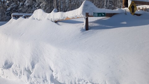 Snow buries a fenced garden north of Fairbanks.