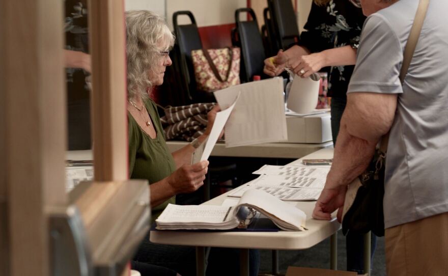 A person sits at a table with paperwork