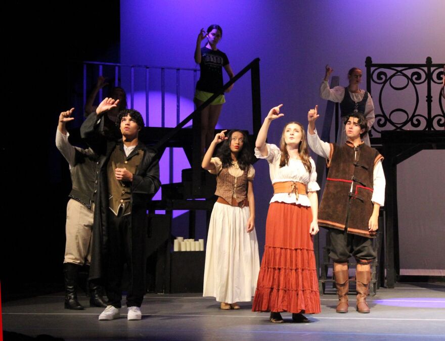 Cast signing lyrics during 'Finale Ultimo' during performance of 'The Hunchback of Notre Dame'