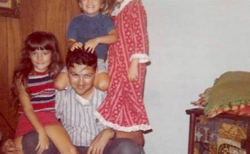 Mickey Finn (center) with Michele, Scott and Beth Finn in 1976, with their TV nearby to the right. Scott says it was most likely turned on, and tuned to Iowa Public Television.