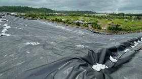 Workers installed a plastic membrane on top of one of the coal ash ponds at Tanners Creek to keep toxic coal ash from running off when it rains.