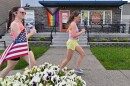 Runners pass the Retro Cafe on Capouse Ave during a training run with the Barrier Breakers.