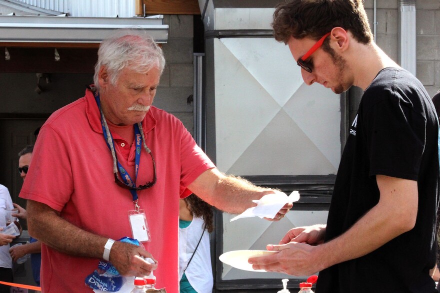 Jordan Goldstein hands out free pancakes to festival-goers. The event was one of several in Gainesville this weekend, including the Chimera Fest, also on Saturday, and Active Streets Gainesville, which occurred Sunday. (Claudia Forster Torres/WUFT News)