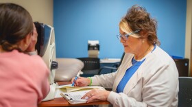 Valley View School District school nurse, Mary Ann Chindemi, works with a student in her office.