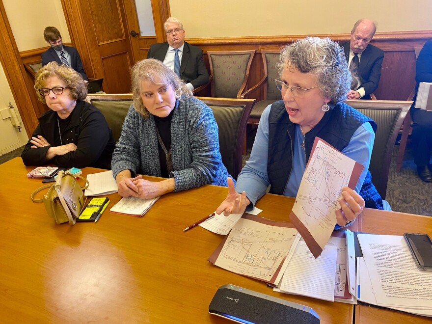 kathy stockdale shows a map of her farm to lawmakers