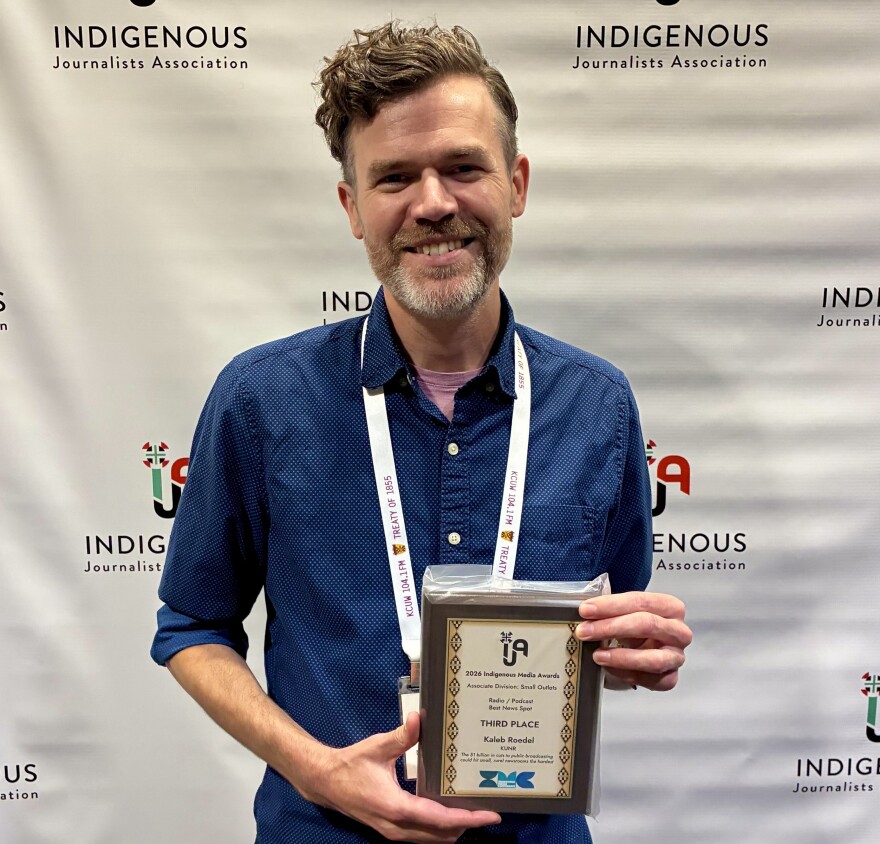 Kaleb Roedel held his award at the Indigenous Journalists Association (IJA) Indigenous Media Awards Banquet on Friday, July 24, 2026.