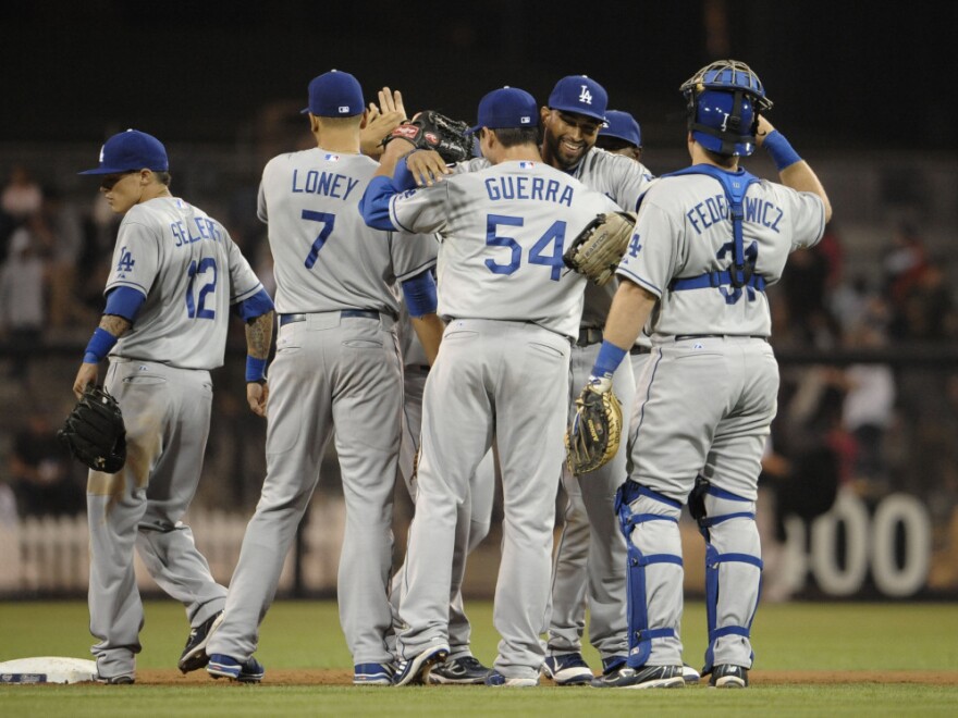 Los Angeles Dodgers players high-five after beating the San Diego Padres 2-0 at Petco Park in San Diego on Sept. 23, 2011. 