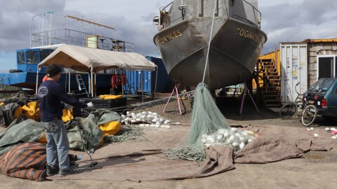 Cullen Chase on the F/V Toonces takes apart a gill net in the Dillingham boatyard after the 2026 sockeye season.