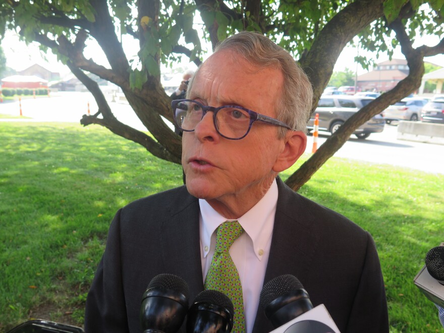 Gov. Mike DeWine talks to reporters after a meeting of the Ohio Expositions Commission.