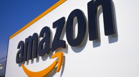 A company logo is seen at the entrance of Amazon. (Michel Spingler/AP)