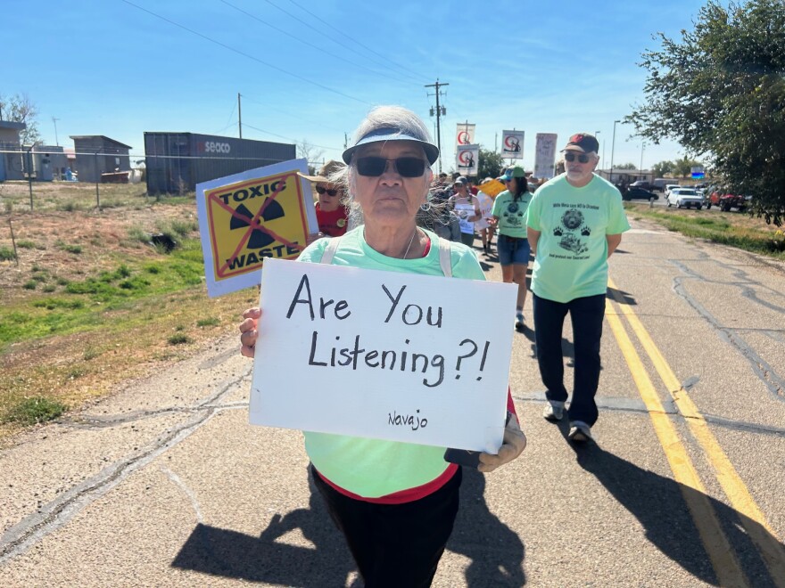 A Navajo citizen and resident of Tuba City holds a sign during the annual protest walk against the mill on Oct. 7, 2023, near White Mesa, Utah, on the Ute Mountain Ute reservation.