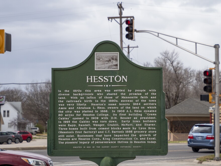 A sign in downtown Hesston notes the city's roots in the Mennonite faith and highlights the legacy of prominent businesses.