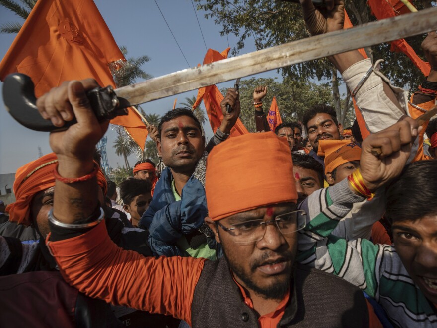 Hindu hard-liners, one holding a sword, chant slogans against Muslim communities during a Nov. 25, 2018, rally demanding a Hindu temple be built on a site in Ayodhya, where attackers in 1992 demolished a 16th century mosque.