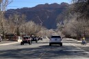 A line of ATVs drive down a street in Moab