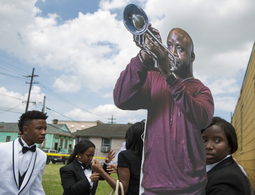 Family and friends carry a life-size cutout of New Orleans musician, Travis "Trumpet Black" Hill, during the jazz funeral for the 28-year-old. Hill died of an infection on May 4, 2015, while on tour in Japan.