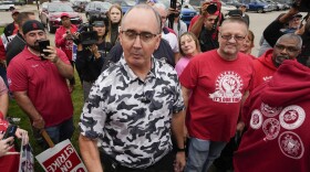 United Auto Workers President Shawn Fain talks with members picketing near a General Motors Assembly Plant in Delta Township, Mich., on Sept. 29, 2023. Fain is scheduled to update members today on bargaining with Detroit automakers as strikes against the companies head into their sixth week.