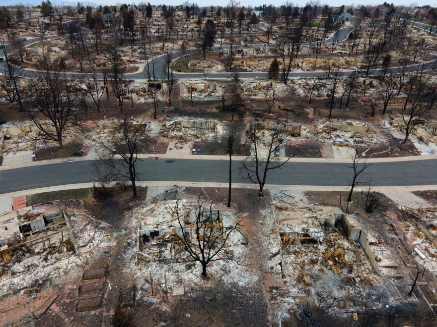 scorched homes from an urban wildfire that burned through Louisville Colorado