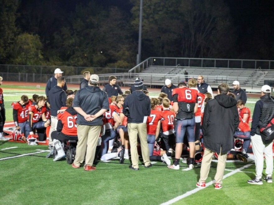 Ozark football huddles up after game last season
