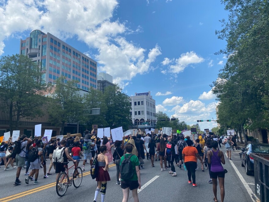 Protesters approach College Avenue on Monroe St. Police blocked off Monroe for 3 minutes at top of every hour for marchers, meant to represent the 3 people killed in Tallahassee police shootings this year.