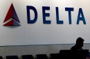 A man waits for a Delta Airlines flight at Hartsfield-Jackson International Airport in Atlanta on Jan. 7, 2022.