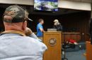 An audience member watches Troy Roberts, the communication and outreach manager for the Suwannee River Water Management District, and John. S. Quarterman, with the Suwannee Riverkeeper at WWALS Watershed Coalition, speak before the meeting on Feb. 5, 2026.