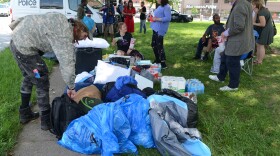 Houseless people who were camping in Westport gather their belongings Sunday morning after being told they had to leave.