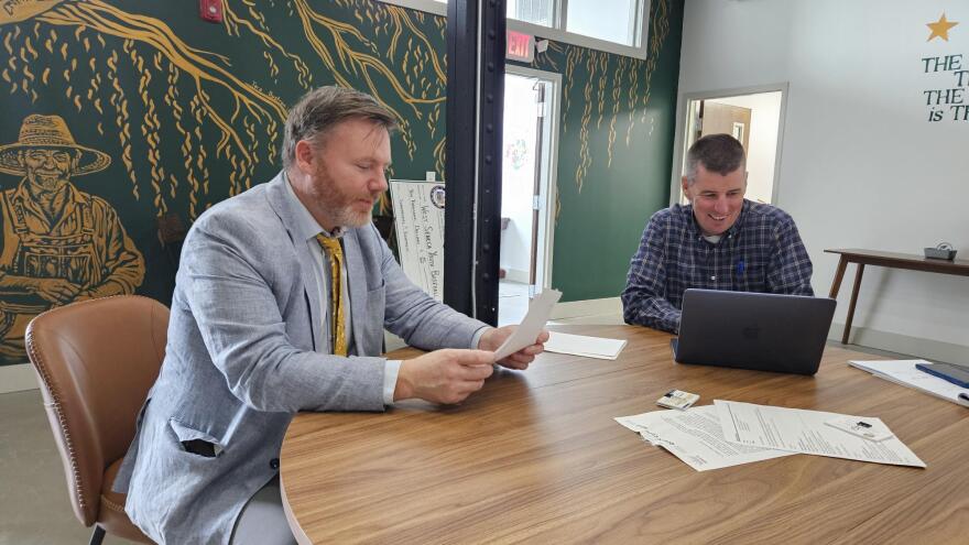 State Assemblymember Pat Burke, left, reviews documents with staff members at his office.