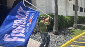 Flag-waver outside Florida governor candidate James Fishback's counter-programming event in Fort Lauderdale on Saturday, June 28, 2026, after he was uninvited from the state Republican party's marquee candidate event.