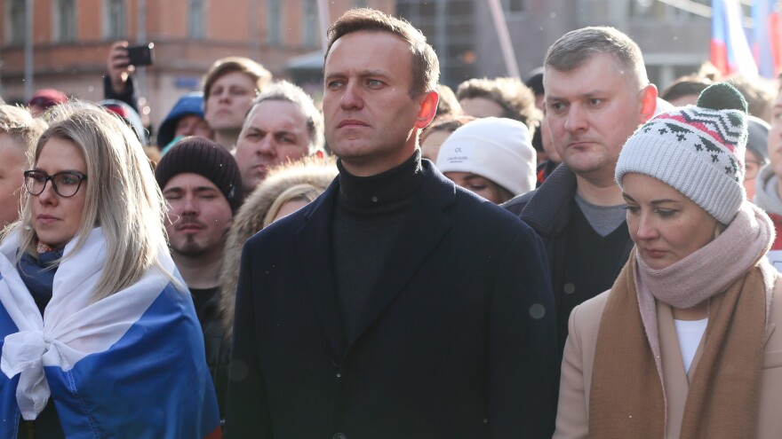 Alexei Navalny is seen during a rally in Moscow last year along with his wife, Yulia (right). She and his personal doctor were reportedly prevented from seeing him in the hospital.